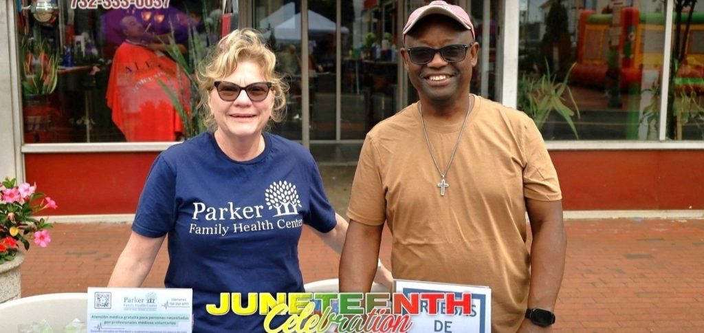 Ana and Burt at Parker's table at the 2025 Juneteenth celebration in Freehold